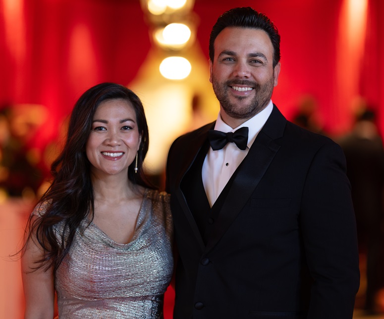 Couple in formal wear posing for a photo.